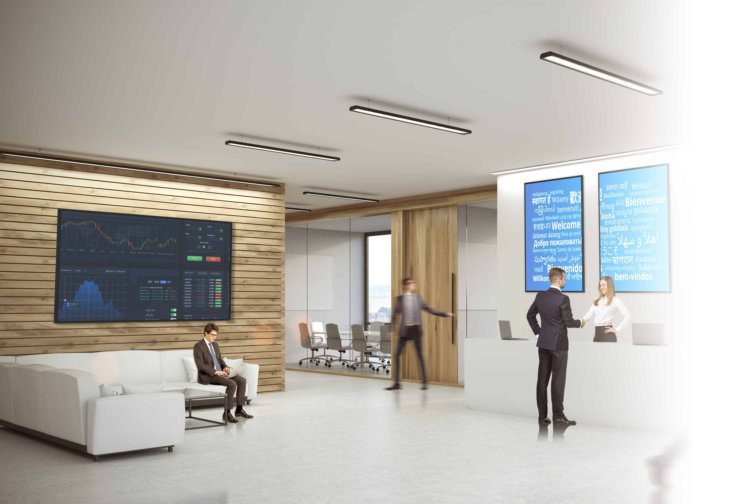 A business person is greeted by a receptionist. Behind the receptionist are two Optoma N Series Professional displays mounted side by side in a vertical arrangement showing the word 'Welcome' in various languages.